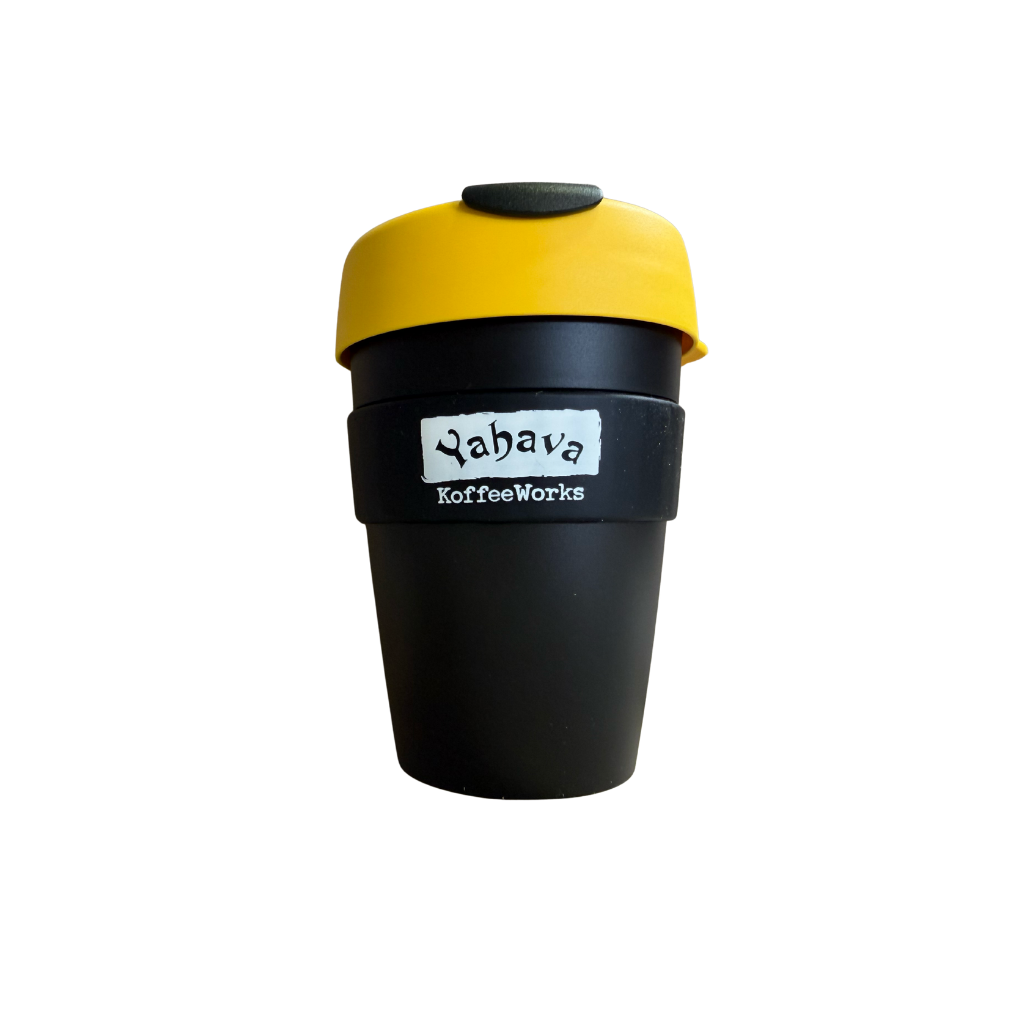 A reusable coffee cup with a matte black body, a bright yellow lid, and a black band around the middle featuring a white label that reads 'Yahava KoffeeWorks'.