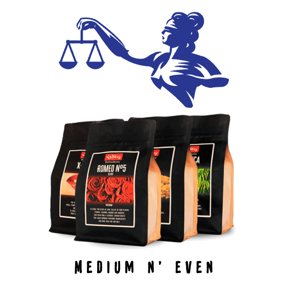 Four black coffee bags including Romeo No5 blend beneath a blindfolded Lady Justice holding scales, with "Medium n' Even" text below
