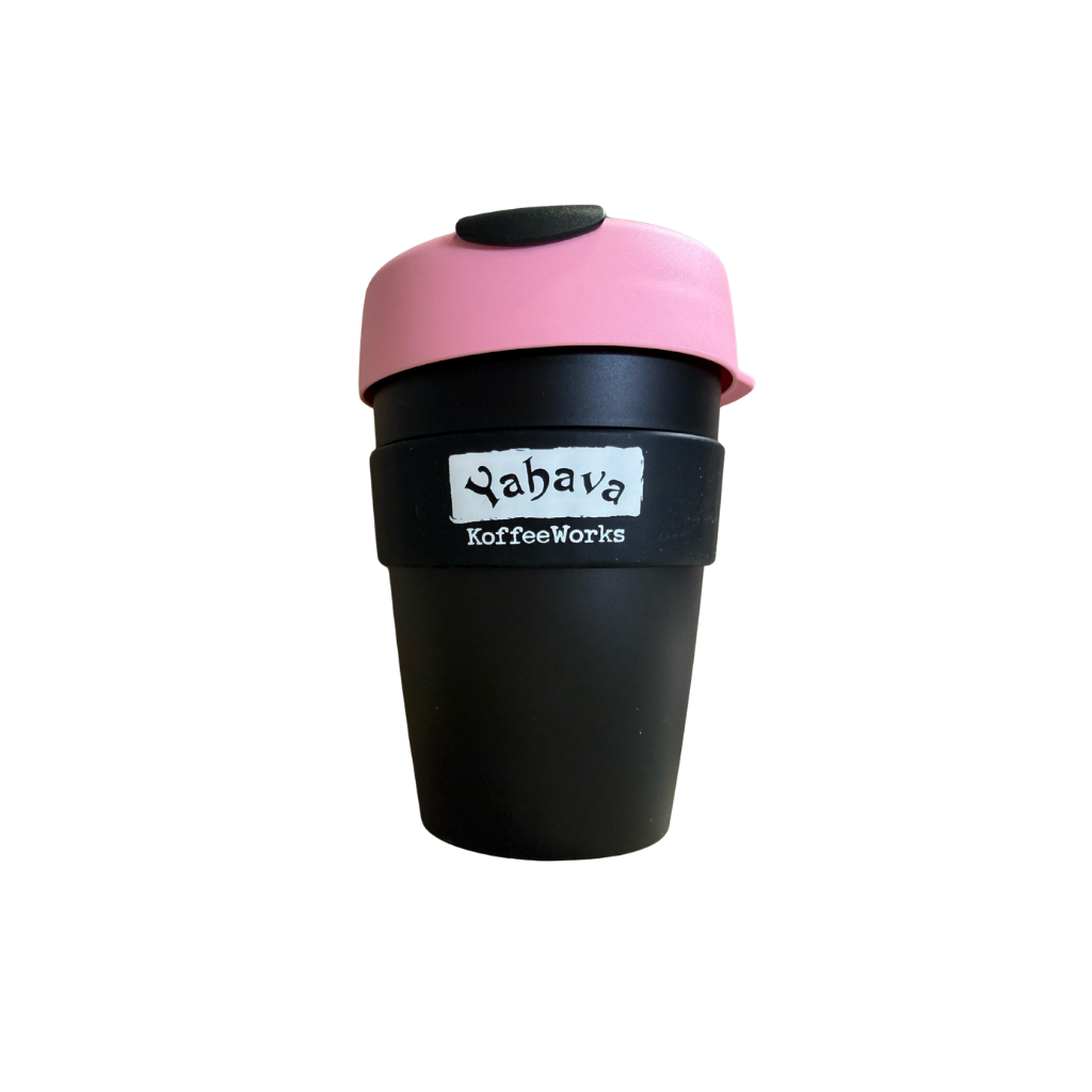 A reusable coffee cup with a black body, a pink lid, and a black band around the middle featuring the white text 'Yahava KoffeeWorks'.