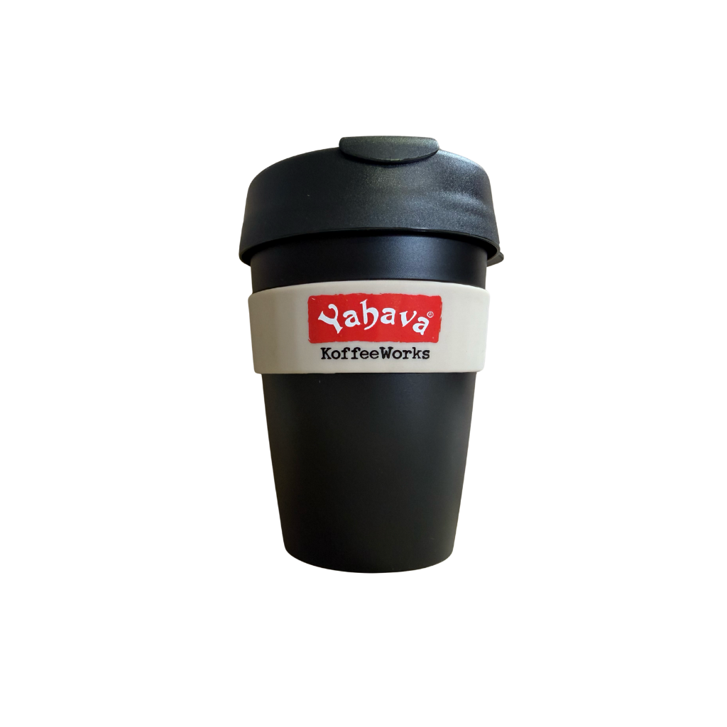 A reusable black coffee cup with a black lid and a beige band around the middle featuring the red and black 'Yahava KoffeeWorks' logo, shown on a plain white background.