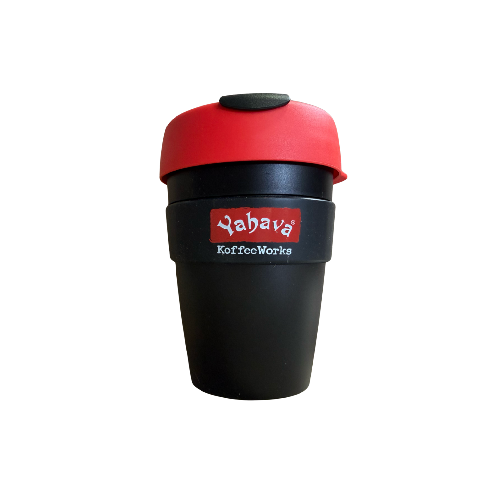 A reusable coffee cup with a matte black body, a red lid, and a black band around the middle featuring the red and white 'Yahava KoffeeWorks' logo, isolated on a white background.