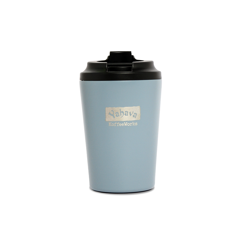 A blue travel mug with a black lid, branded with Yahava KoffeeWorks on the front.