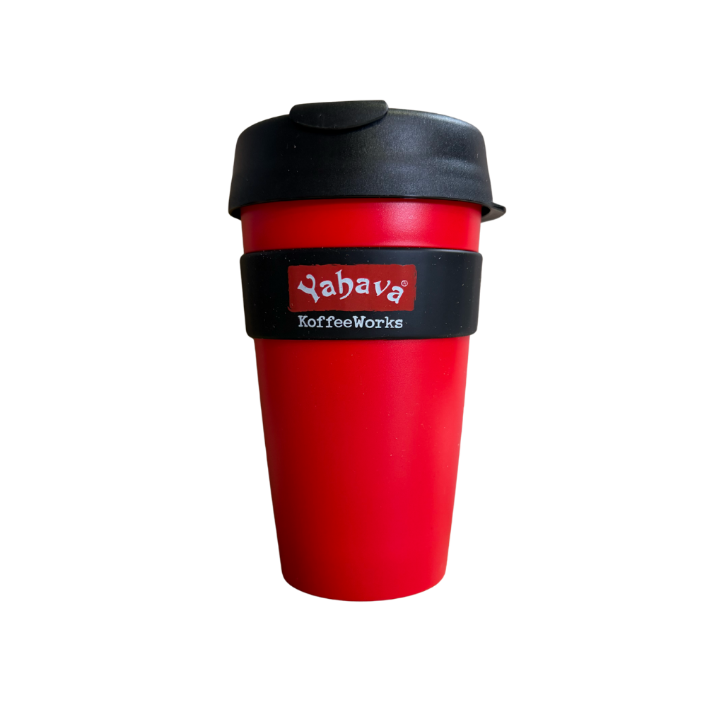 A red reusable travel tumbler with a black lid and a black band around the middle featuring the 'Yahavă KoffeeWorks' logo, shown on a plain white background.