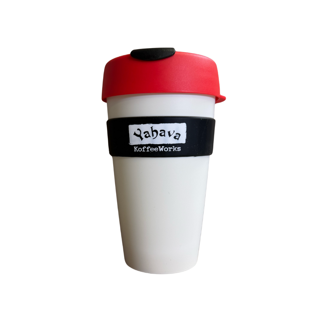 A reusable coffee cup with a white body, a red lid, and a black silicone band around the middle that reads 'Yahava Koffee Works'.