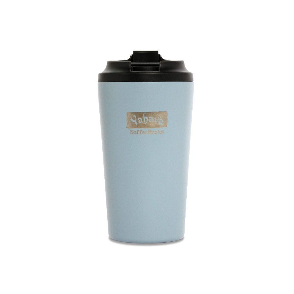 A blue travel mug with a black lid, branded with Yahava KoffeeWorks on the front. 