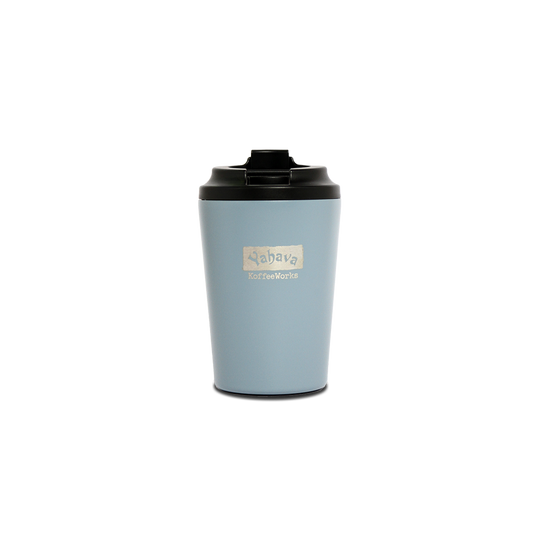 A blue travel mug with a black lid, branded with Yahava KoffeeWorks on the front.
