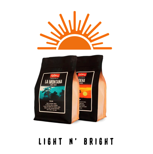 Two black coffee bags labeled La Montaña and Mokha beneath an orange sunburst icon, with "Light n' Bright" text below
