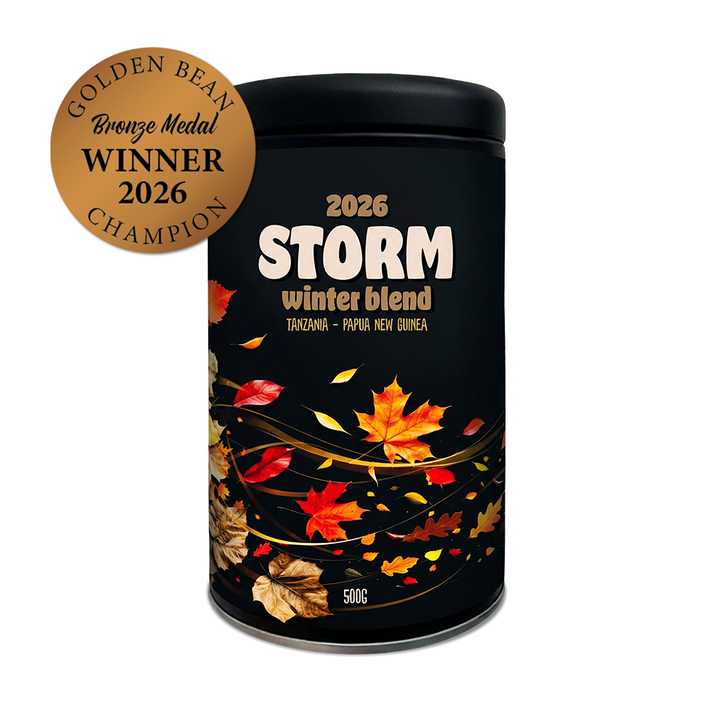 Black container labeled '2026 Storm winter blend' with autumn leaf design on a white background. Golden Bean Bronze Medal Winner 2026 label