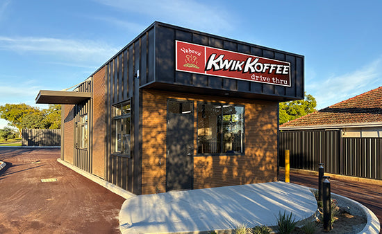 Kwik Koffee St. James store with wrap around drive and garden