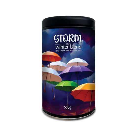 Coffee canister labelled 'Storm Winter Blend' with colourful umbrellas on a blue background