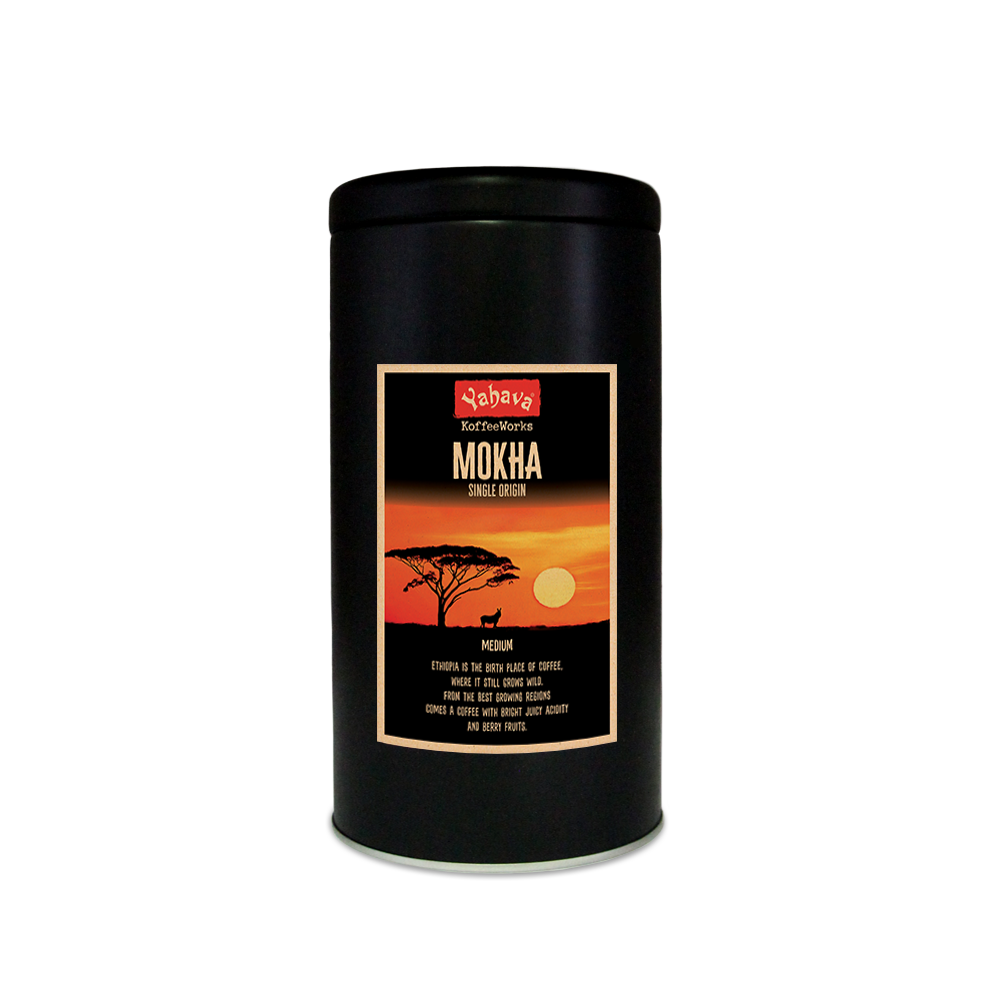 A black 500g tin with Yahava Signature Range coffee label for Mokha on the tin featuring a glowing sunset of the African safari a tree and Zebra. 